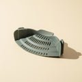 SwiftFix Silicone Clip-On Pot Strainer on a cream studio background