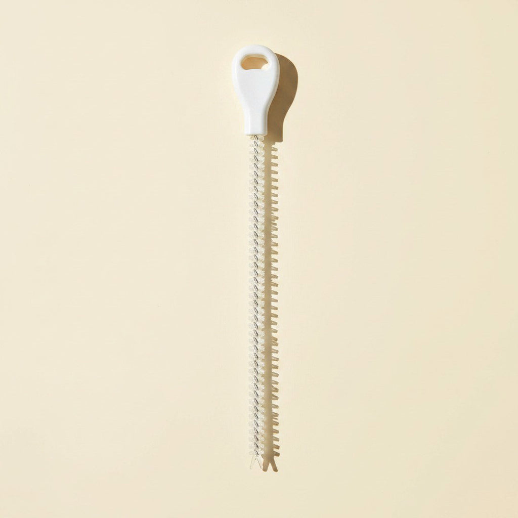 SwiftFix Flexible Drain Hair Remover on a cream studio background