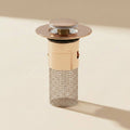SwiftFix Pop-Up Sink Hair Strainer on a cream studio background